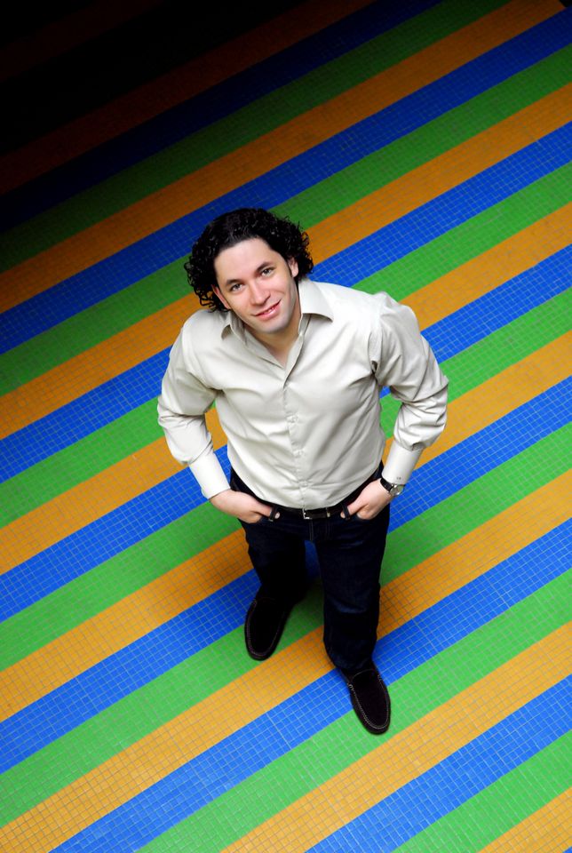 Gustavo Dudamel - composer on an orange, blue and green striped background